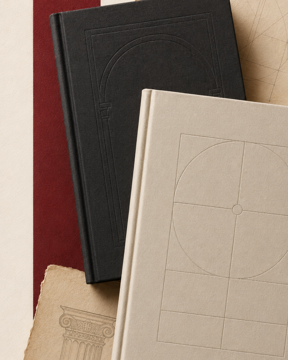 Black and ivory clothbound books arranged with archival papers